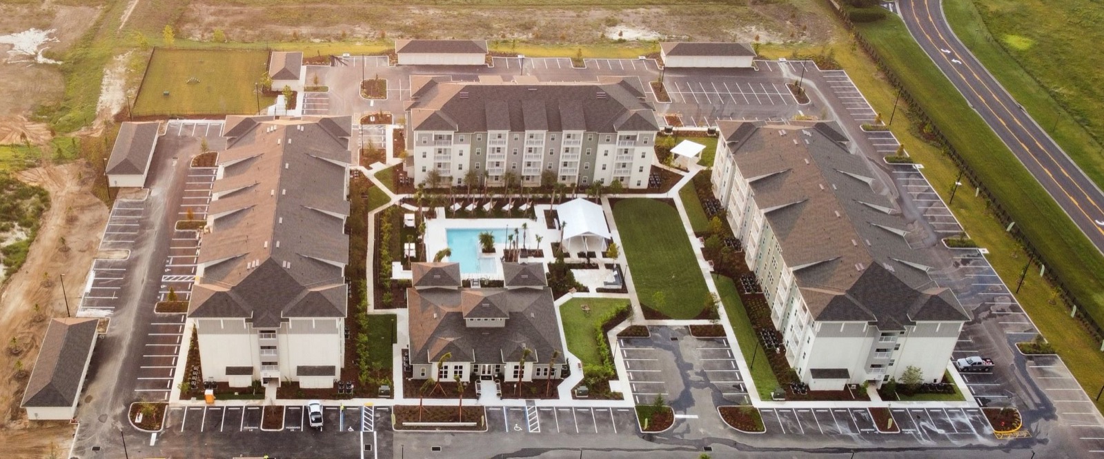 Aerial view of all five Livano Wildwood buildings around the pool and clubhouse