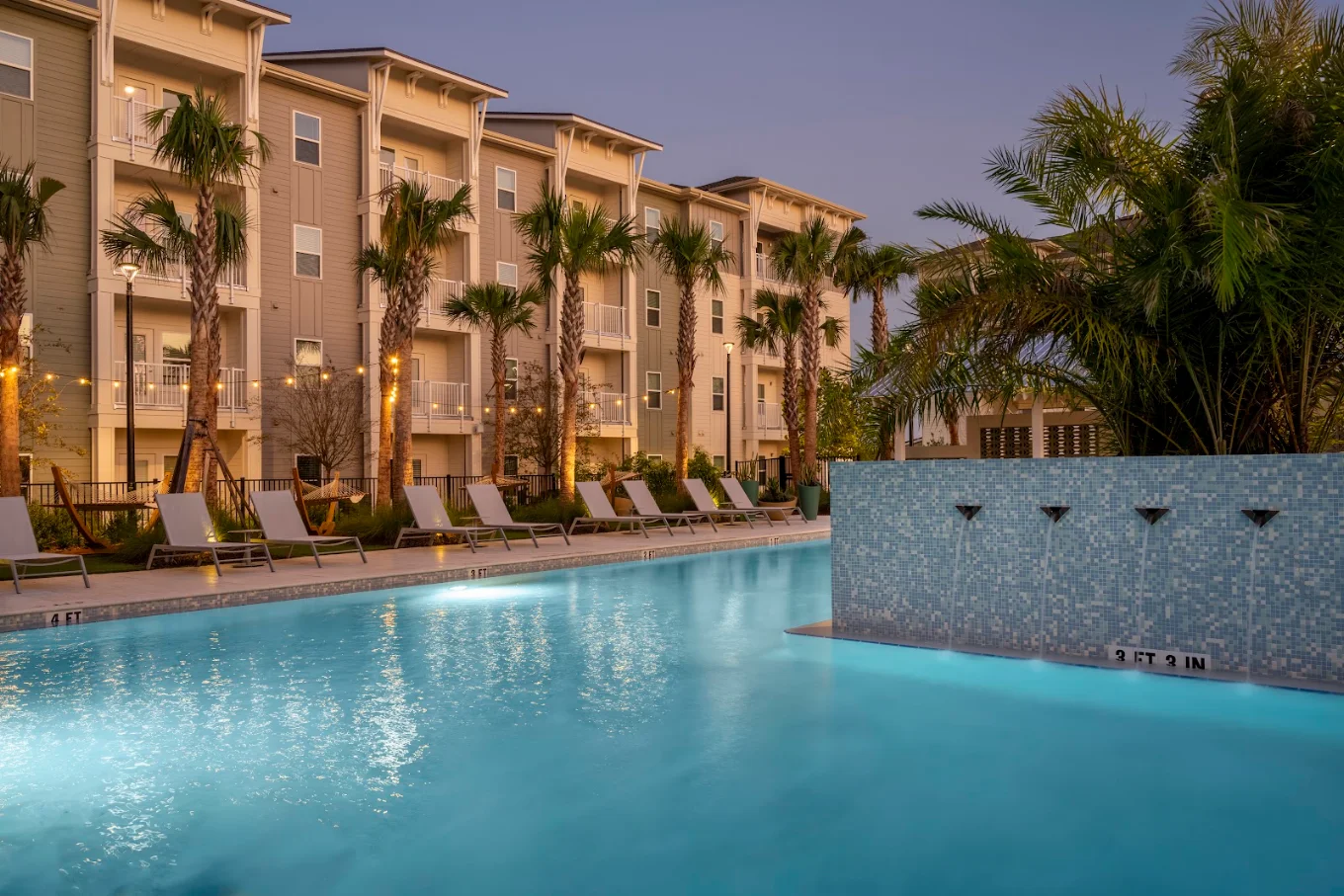 Livano Wildwood building elevations beside the pool at dusk